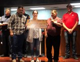 Tachi Palace General Manager Willie Barrios presents a $5,000 check to Crystal Hernandez, wife of Kings County Firefighter Keith Hernandez who is battling cancer.